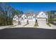 Three new townhomes with attached garages and modern white and gray exteriors and hardscaped yards at 518 Scenic Pass, Woodstock, GA 30189