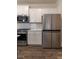 Modern stainless steel refrigerator and gas stove in a white subway tile kitchen at 518 Scenic Pass, Woodstock, GA 30189