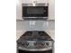 Modern stainless steel microwave and gas cooktop in a white subway tile kitchen at 518 Scenic Pass, Woodstock, GA 30189