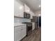 Bright kitchen featuring white cabinets, stainless steel appliances, and hardwood floors at 518 Scenic Pass, Woodstock, GA 30189