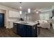 Open-concept kitchen with a center island, modern lighting, and stainless steel appliances at 518 Scenic Pass, Woodstock, GA 30189