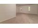 Spacious room with neutral carpet, bright natural light, and a back door at 518 Scenic Pass, Woodstock, GA 30189