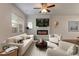 Bright living room with ceiling fan, fireplace, and plush neutral furnishings at 518 Scenic Pass, Woodstock, GA 30189