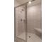 Tiled shower with glass door and marble-style walls for a luxurious feel at 518 Scenic Pass, Woodstock, GA 30189