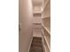 Organized walk-in closet with built-in shelving and hardwood floors at 518 Scenic Pass, Woodstock, GA 30189