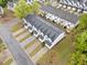 Aerial view of townhome community showcasing roof lines, landscaping, and street layout at 6703 Gallant Se Ct, Mableton, GA 30126