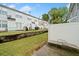Fenced backyard featuring a lawn, retaining wall, concrete patio, and lounge chair at 6703 Gallant Se Ct, Mableton, GA 30126