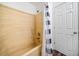 Bathroom with shower and bathtub combo and blue and white striped shower curtain at 6703 Gallant Se Ct, Mableton, GA 30126