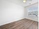 Well-lit bedroom with hardwood floors, ceiling fan, and large window offering ample natural light at 6703 Gallant Se Ct, Mableton, GA 30126