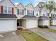 Townhome exterior featuring attached garages, neutral siding, and manicured landscaping at 6703 Gallant Se Ct, Mableton, GA 30126