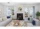 Bright living room features fireplace, neutral furniture, large windows, and access to outdoor patio at 6703 Gallant Se Ct, Mableton, GA 30126