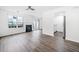 Open-concept living room showcases modern floors, fireplace, and seamless flow to the adjacent kitchen area at 6703 Gallant Se Ct, Mableton, GA 30126