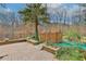 Backyard view shows pond, wooden bridge, brick patios, manicured beds, and perimeter fencing at 725 Links View Dr, Sugar Hill, GA 30518
