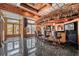 Rustic-style bar area with thatched roof, seating, large window, and dark granite tile floor at 725 Links View Dr, Sugar Hill, GA 30518