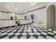 Opulent bathroom featuring a jacuzzi tub, dual sink vanity and classic black and white checkered flooring at 725 Links View Dr, Sugar Hill, GA 30518