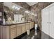 Modern bathroom features marble style wall and floor tiles and double sink vanity and large mirrors at 725 Links View Dr, Sugar Hill, GA 30518
