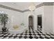 This bathroom offers checkered floors, a jacuzzi tub, an intricate chandelier, and a separate toilet room at 725 Links View Dr, Sugar Hill, GA 30518