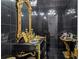 Features a stylish vanity with a gold accented mirror and black tile walls at 725 Links View Dr, Sugar Hill, GA 30518