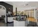 Features a kitchen island, modern cabinetry and hardwood floors leading to the main living area at 725 Links View Dr, Sugar Hill, GA 30518