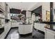 A spacious kitchen features an island, black backsplash, and views to the outdoors at 725 Links View Dr, Sugar Hill, GA 30518