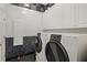 The laundry room features modern appliances and white storage cabinets at 725 Links View Dr, Sugar Hill, GA 30518