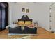 Bedroom features a luxurious bed and a stylish chandelier at 725 Links View Dr, Sugar Hill, GA 30518