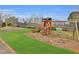 Community playground area with wooden playset, swings, and climbing equipment on a grassy lawn at 725 Links View Dr, Sugar Hill, GA 30518