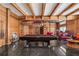 Large recreation room featuring exposed beams, a pool table, tile floors, and seating area at 725 Links View Dr, Sugar Hill, GA 30518