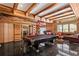 Large recreation room featuring exposed beams, a pool table, tile floors, and seating area at 725 Links View Dr, Sugar Hill, GA 30518