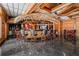 Unique wet bar features a thatched roof, dark countertops, and dark marble floors for a tropical aesthetic at 725 Links View Dr, Sugar Hill, GA 30518