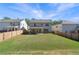 Large backyard featuring a well-maintained lawn, a wooden fence, and a covered patio area for entertaining at 1840 Wellston Dr, Lawrenceville, GA 30043