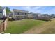 Spacious backyard with a green lawn, wooden fencing, and a covered patio ideal for outdoor gatherings at 1840 Wellston Dr, Lawrenceville, GA 30043
