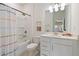 Bright bathroom featuring a shower/tub combo, modern vanity, and stylish decor with colorful accents at 1840 Wellston Dr, Lawrenceville, GA 30043