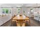 Bright and airy dining room featuring a large wooden table, seating for eight, and view to kitchen at 1840 Wellston Dr, Lawrenceville, GA 30043