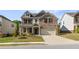 Charming brick two-story home with a well-manicured lawn and a two-car garage at 1840 Wellston Dr, Lawrenceville, GA 30043
