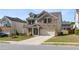 Charming two-story home with brick and siding, a covered porch, and an attached two-car garage at 1840 Wellston Dr, Lawrenceville, GA 30043