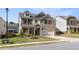 Inviting two-story brick and siding home featuring a covered porch and well-manicured front yard at 1840 Wellston Dr, Lawrenceville, GA 30043
