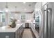 Bright kitchen with gray island, stainless appliances, white cabinets, and hardwood flooring at 1840 Wellston Dr, Lawrenceville, GA 30043