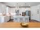 Modern kitchen with stainless steel appliances, white cabinets, island with seating, and modern pendant lights at 1840 Wellston Dr, Lawrenceville, GA 30043
