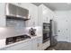 Modern kitchen with stainless steel appliances, white cabinets, and subway tile backsplash at 1840 Wellston Dr, Lawrenceville, GA 30043