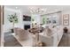 Inviting living room with a fireplace, white furniture, and large windows providing ample natural light and tree views at 1840 Wellston Dr, Lawrenceville, GA 30043