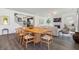 Open-concept living room and dining area featuring hardwood floors, bright natural light, and fireplace at 1840 Wellston Dr, Lawrenceville, GA 30043