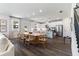 Inviting living space featuring a long wooden table and view to a modern kitchen with stainless steel appliances at 1840 Wellston Dr, Lawrenceville, GA 30043