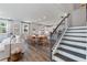 Spacious open-concept living space with kitchen, dining area, and staircase featuring stylish modern decor at 1840 Wellston Dr, Lawrenceville, GA 30043