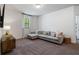 Comfortable loft area with plush carpet, sectional sofa, side table, and window at 1840 Wellston Dr, Lawrenceville, GA 30043