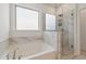 Bright primary bathroom with a soaking tub and a glass-enclosed shower, providing a spa-like experience at 1840 Wellston Dr, Lawrenceville, GA 30043