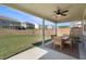 Covered outdoor patio with dining table and chairs overlooking a spacious backyard at 1840 Wellston Dr, Lawrenceville, GA 30043