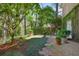 Landscaped backyard with stone pathways and lush greenery beside the brick house at 2000 Old Dominion Rd, Atlanta, GA 30350