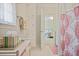 Bright bathroom featuring a white vanity, linen tower and colorful patterned shower curtain at 2000 Old Dominion Rd, Atlanta, GA 30350