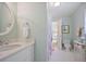 Stylish bathroom featuring a sleek white vanity and a glimpse into an adjacent bedroom at 2000 Old Dominion Rd, Atlanta, GA 30350
